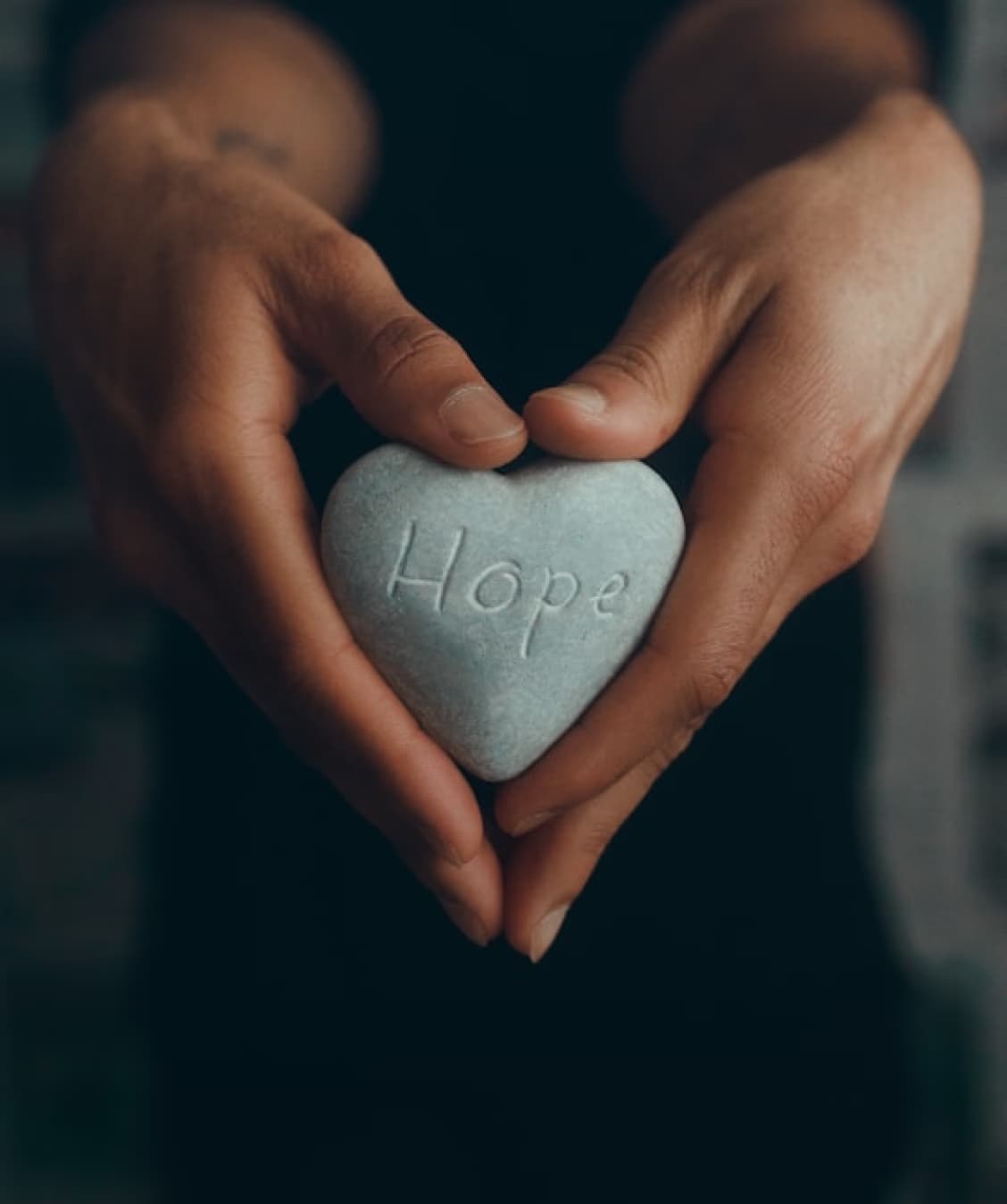 Hands holding heart with hope